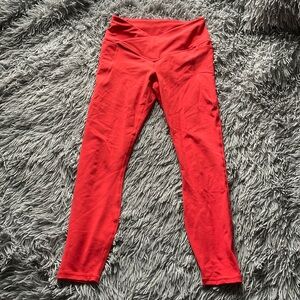Red Fabletics leggings with a crossover waist in the front